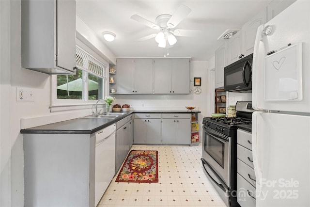 261 Forest Hill Dr, Asheville, NC 28803 - kitchen featuring white appliances, gray cabinetry, dark countertops, ceiling fan, and light flooring