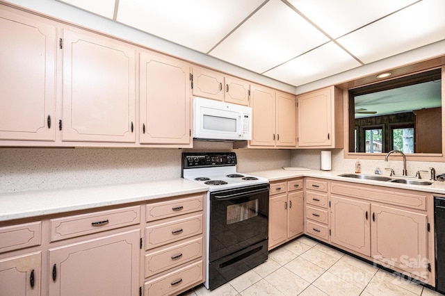4783 Calico Rd, Lenoir, NC 28645 - kitchen with white microwave, electric stove, a sink, light tile patterned flooring, and light countertops