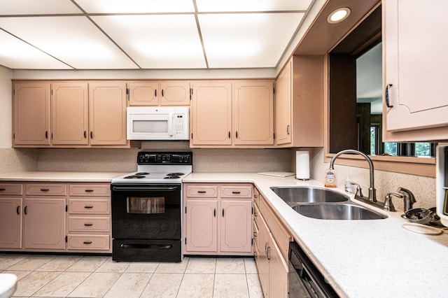 4783 Calico Rd, Lenoir, NC 28645 - kitchen with white microwave, electric range, a sink, light countertops, and light tile patterned floors