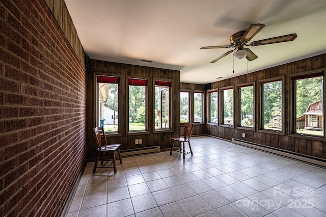 4783 Calico Rd, Lenoir, NC 28645 - sunroom featuring plenty of natural light, brick wall, a baseboard heating unit, tile patterned flooring, and wooden walls