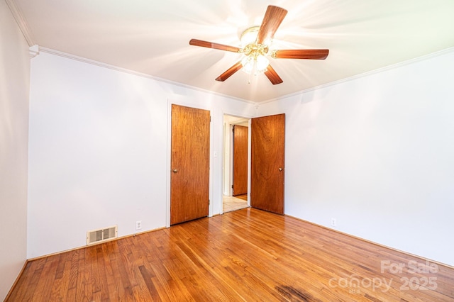 4783 Calico Rd, Lenoir, NC 28645 - empty room featuring crown molding, wood finished floors, and a ceiling fan