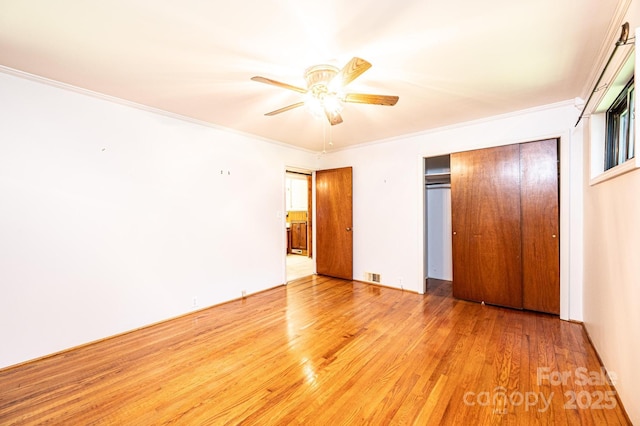 4783 Calico Rd, Lenoir, NC 28645 - unfurnished bedroom featuring light wood-type flooring, ornamental molding, a closet, and ceiling fan