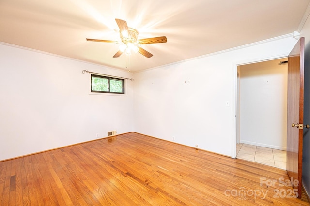 4783 Calico Rd, Lenoir, NC 28645 - empty room featuring crown molding, a ceiling fan, and light wood-type flooring