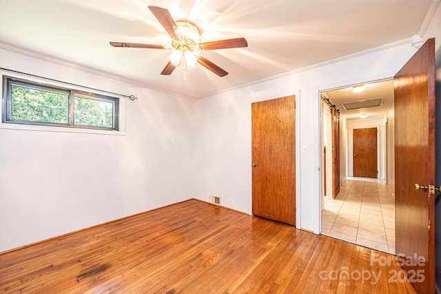 4783 Calico Rd, Lenoir, NC 28645 - unfurnished bedroom with crown molding, wood finished floors, and a ceiling fan
