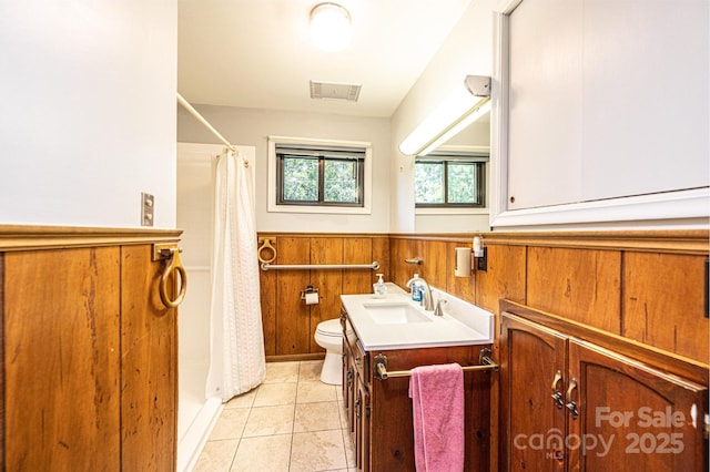 4783 Calico Rd, Lenoir, NC 28645 - bathroom featuring vanity, toilet, a wainscoted wall, curtained shower, and tile patterned flooring