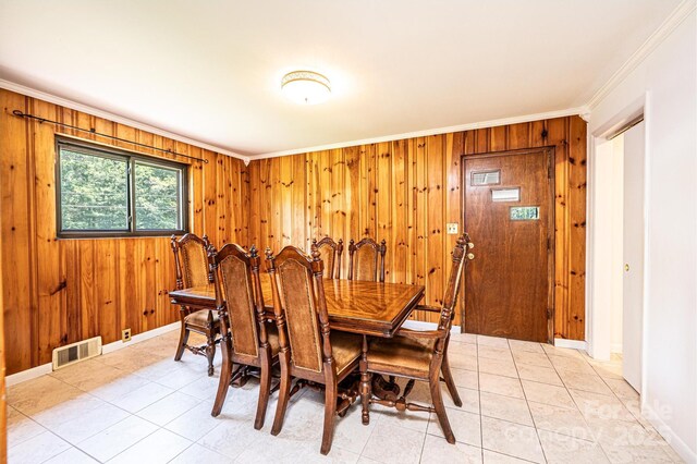4783 Calico Rd, Lenoir, NC 28645 - dining room featuring crown molding, wooden walls, and light tile patterned floors