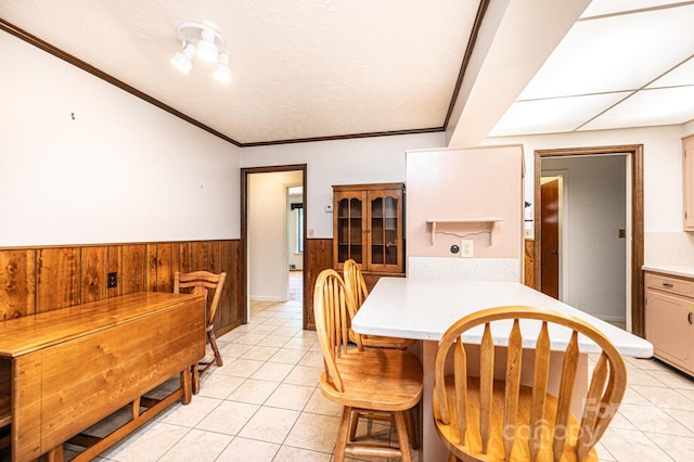 4783 Calico Rd, Lenoir, NC 28645 - dining area featuring wainscoting, light tile patterned flooring, and wooden walls