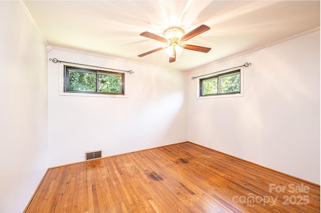 4783 Calico Rd, Lenoir, NC 28645 - spare room featuring crown molding, a ceiling fan, and hardwood / wood-style floors