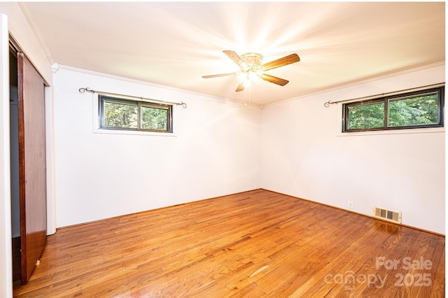4783 Calico Rd, Lenoir, NC 28645 - unfurnished bedroom featuring crown molding, light wood-type flooring, ceiling fan, and a closet