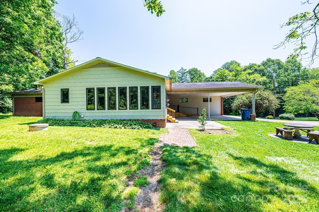 4783 Calico Rd, Lenoir, NC 28645 - rear view of house featuring a yard and a carport