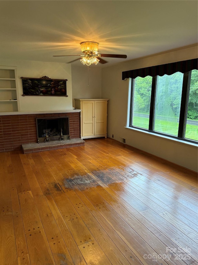 4783 Calico Rd, Lenoir, NC 28645 - unfurnished living room featuring hardwood / wood-style floors, a ceiling fan, and a fireplace