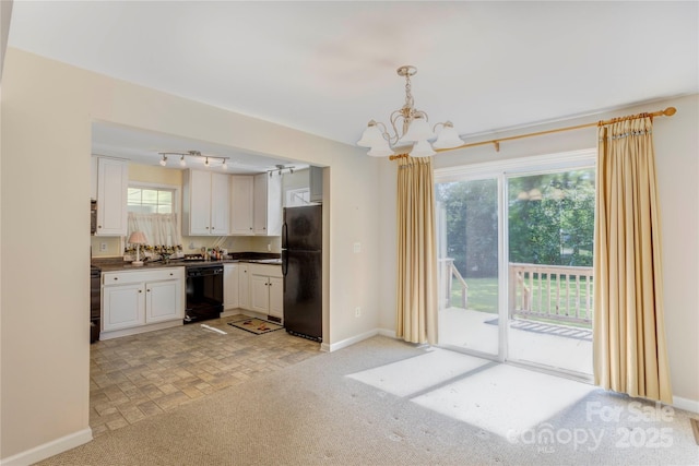 2105 Florida Ave, Kannapolis, NC 28083 - kitchen featuring black appliances, dark countertops, a chandelier, white cabinetry, and baseboards