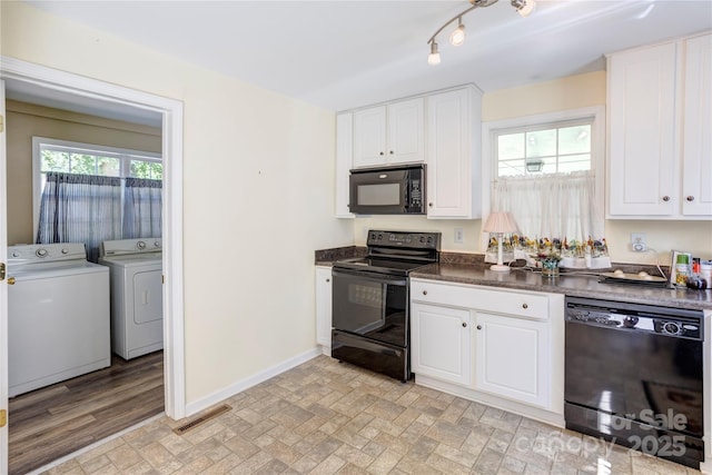 2105 Florida Ave, Kannapolis, NC 28083 - kitchen featuring black appliances, washing machine and dryer, baseboards, dark countertops, and white cabinetry