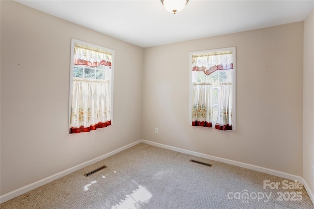 2105 Florida Ave, Kannapolis, NC 28083 - carpeted empty room featuring plenty of natural light and baseboards