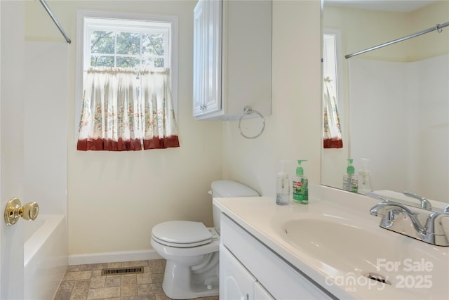 2105 Florida Ave, Kannapolis, NC 28083 - bathroom featuring toilet, vanity, baseboards, and bathing tub / shower combination