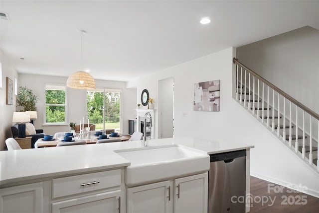 16112 Langston Dr, Charlotte, NC 28278 - kitchen with dishwasher, dark wood-style flooring, light countertops, white cabinetry, and pendant lighting