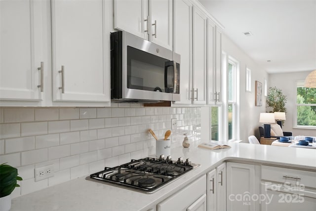 16112 Langston Dr, Charlotte, NC 28278 - kitchen with stainless steel appliances, white cabinetry, and light countertops