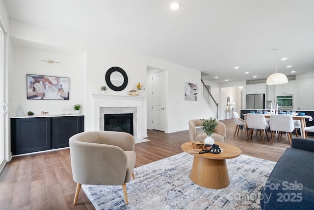 16112 Langston Dr, Charlotte, NC 28278 - living area with wood finished floors, stairway, recessed lighting, and a premium fireplace