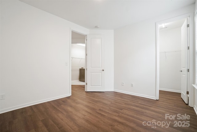 16112 Langston Dr, Charlotte, NC 28278 - unfurnished bedroom with dark wood-style floors, a walk in closet, and a closet