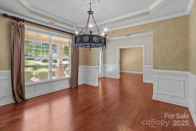 126 Northbridge Dr, Mooresville, NC 28115 - unfurnished dining area featuring a chandelier, wainscoting, a raised ceiling, wood finished floors, and ornamental molding