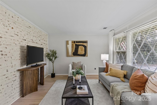 5329 Valley Forge Rd, Charlotte, NC 28210 - living room featuring ornamental molding, light wood finished floors, and brick wall
