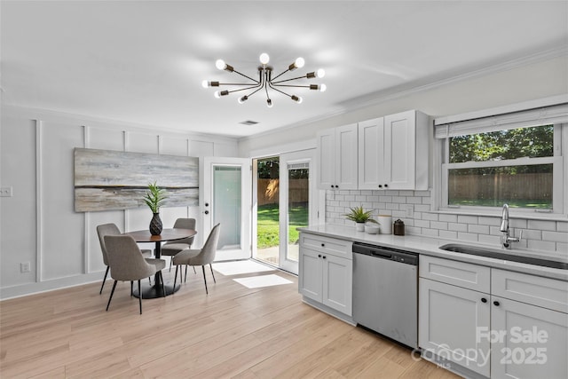 5329 Valley Forge Rd, Charlotte, NC 28210 - kitchen featuring stainless steel dishwasher, a chandelier, light countertops, plenty of natural light, and crown molding