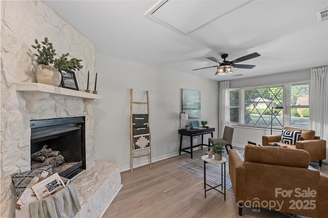 5329 Valley Forge Rd, Charlotte, NC 28210 - living area with light wood-style floors, a fireplace, ceiling fan, and attic access