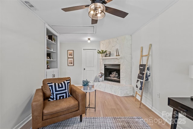 5329 Valley Forge Rd, Charlotte, NC 28210 - living area with a ceiling fan, light wood finished floors, a premium fireplace, and ornamental molding