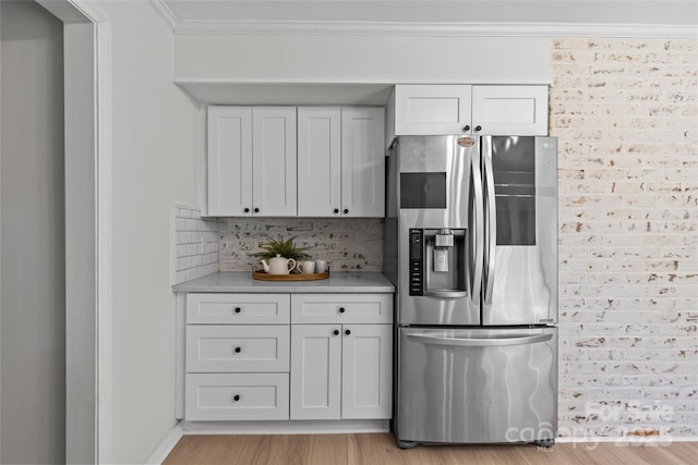 5329 Valley Forge Rd, Charlotte, NC 28210 - kitchen featuring stainless steel fridge with ice dispenser, tasteful backsplash, light countertops, crown molding, and white cabinetry