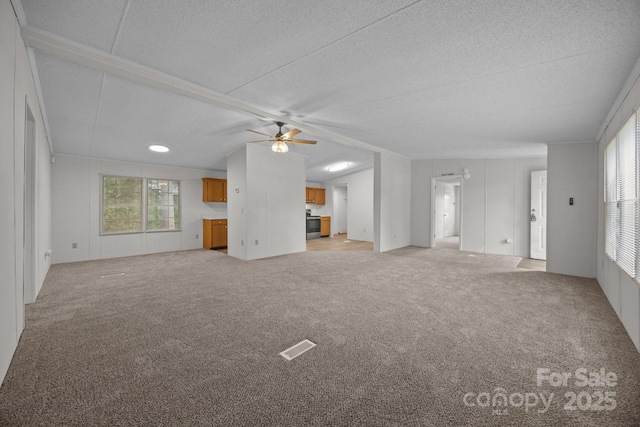 1011 Rachel Ln, Salisbury, NC 28147 - unfurnished living room featuring a ceiling fan, light colored carpet, and a textured ceiling