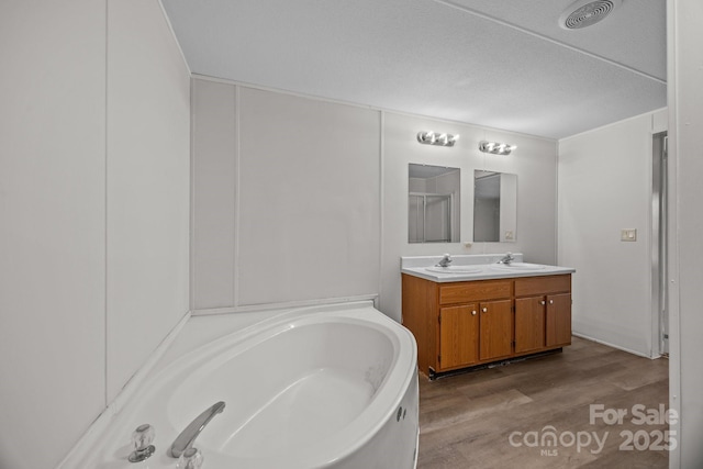 1011 Rachel Ln, Salisbury, NC 28147 - bathroom with double vanity, a bath, and wood finished floors