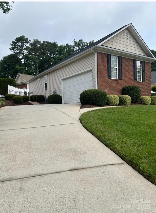 2300 Wednesbury Ct, Kannapolis, NC 28083 - view of side of home featuring a garage, concrete driveway, brick siding, and a lawn