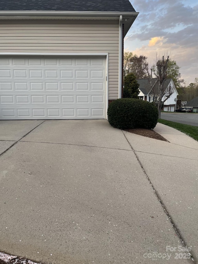 2300 Wednesbury Ct, Kannapolis, NC 28083 - garage at dusk featuring concrete driveway