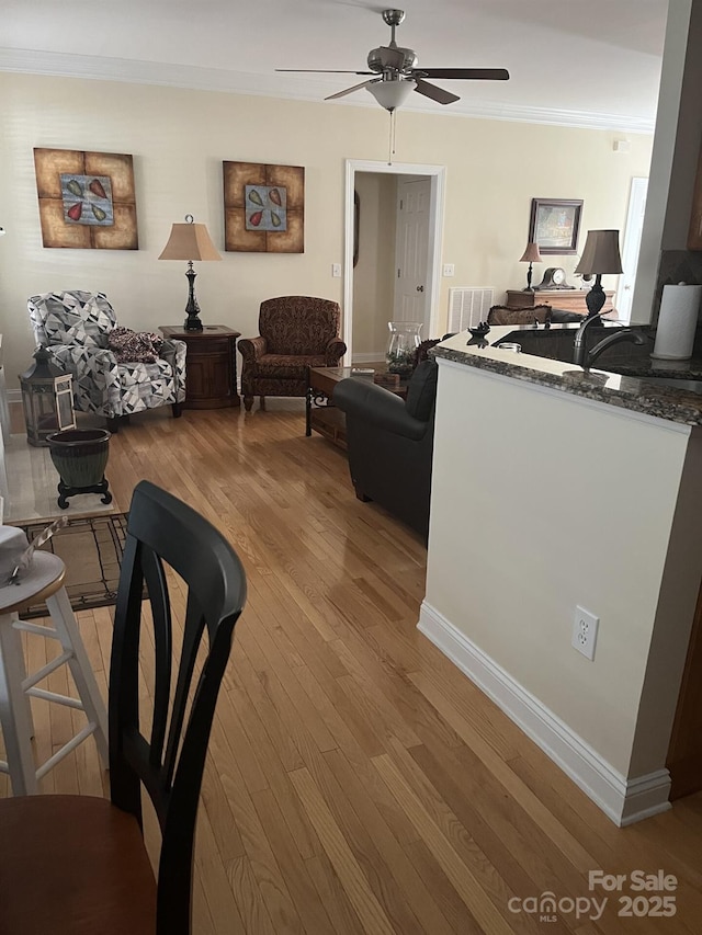 2300 Wednesbury Ct, Kannapolis, NC 28083 - living area featuring light wood-type flooring, ceiling fan, and crown molding