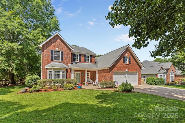 1624 Moonstone Dr, Matthews, NC 28105 - view of front facade featuring brick siding, driveway, and a front lawn