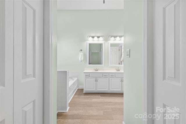 1624 Moonstone Dr, Matthews, NC 28105 - bathroom with double vanity, a bath, and wood finished floors