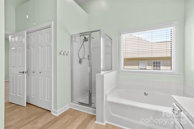 1624 Moonstone Dr, Matthews, NC 28105 - bathroom featuring a shower stall, wood finished floors, a bath, and vanity