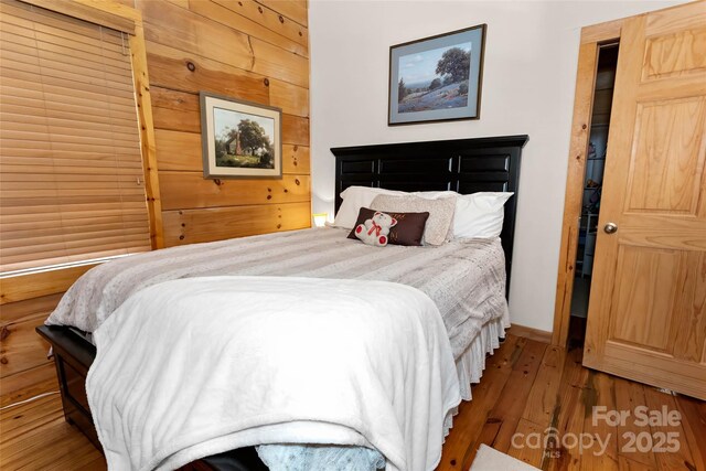 853 Granny Lewis Ln, Mars Hill, NC 28754 - bedroom with hardwood / wood-style flooring and wood walls