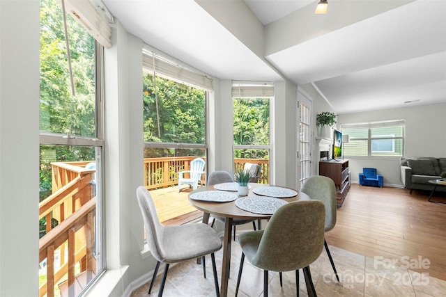 7425 Hubbard Woods Rd, Charlotte, NC 28269 - dining room with a fireplace and wood finished floors