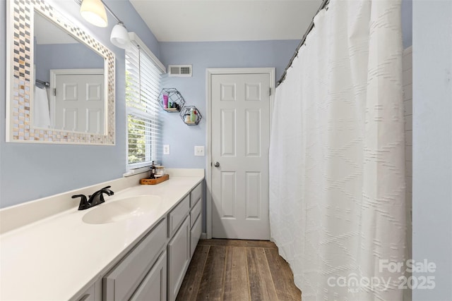 7425 Hubbard Woods Rd, Charlotte, NC 28269 - full bathroom with wood finished floors and vanity