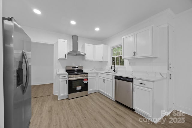 442 Lovelace Rd, Rock Hill, SC 29730 - kitchen featuring appliances with stainless steel finishes, wall chimney range hood, white cabinets, light wood-style flooring, and light stone counters