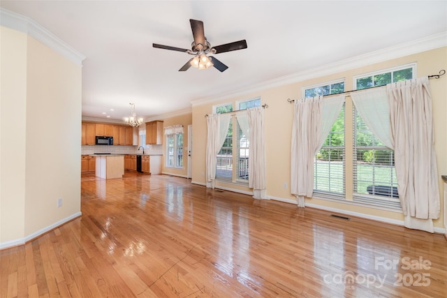 1002 Hollyhedge Ln, Indian Trail, NC 28079 - unfurnished living room featuring a chandelier, ornamental molding, light wood finished floors, and a ceiling fan