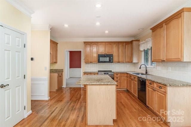 1002 Hollyhedge Ln, Indian Trail, NC 28079 - kitchen with black appliances, ornamental molding, light stone countertops, a kitchen island, and light wood-type flooring