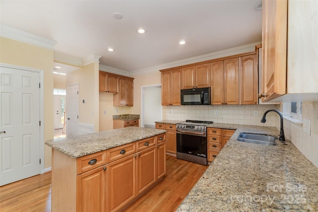 1002 Hollyhedge Ln, Indian Trail, NC 28079 - kitchen featuring stainless steel range, black microwave, light stone countertops, ornamental molding, and light wood-type flooring