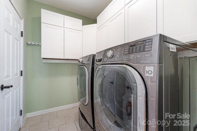 1002 Hollyhedge Ln, Indian Trail, NC 28079 - laundry room featuring cabinet space, washer and clothes dryer, and light tile patterned floors