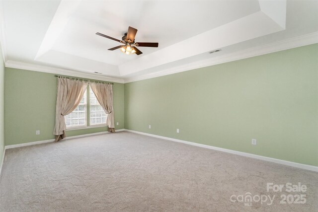 1002 Hollyhedge Ln, Indian Trail, NC 28079 - unfurnished room with a raised ceiling, a ceiling fan, crown molding, and carpet floors