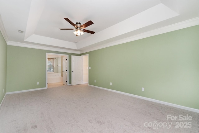 1002 Hollyhedge Ln, Indian Trail, NC 28079 - unfurnished room featuring a raised ceiling, a ceiling fan, ornamental molding, and light carpet