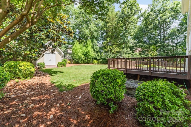 1002 Hollyhedge Ln, Indian Trail, NC 28079 - view of green lawn with a storage unit and a wooden deck