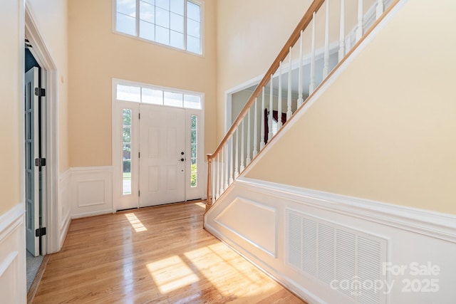 1002 Hollyhedge Ln, Indian Trail, NC 28079 - entrance foyer featuring a decorative wall, healthy amount of natural light, wood finished floors, wainscoting, and a high ceiling