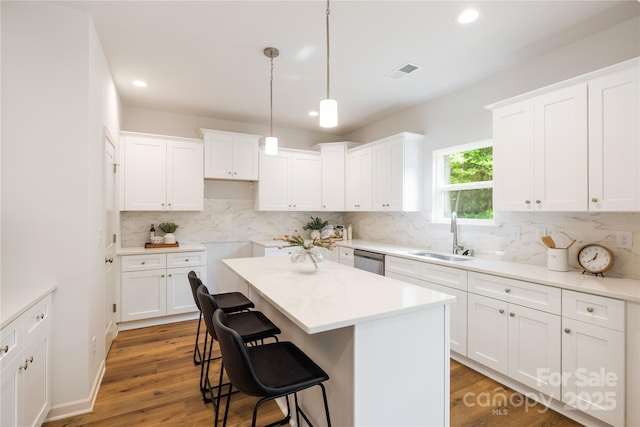 4226 Acorn St, Charlotte, NC 28205 - kitchen featuring a sink, a center island, recessed lighting, a breakfast bar area, and tasteful backsplash
